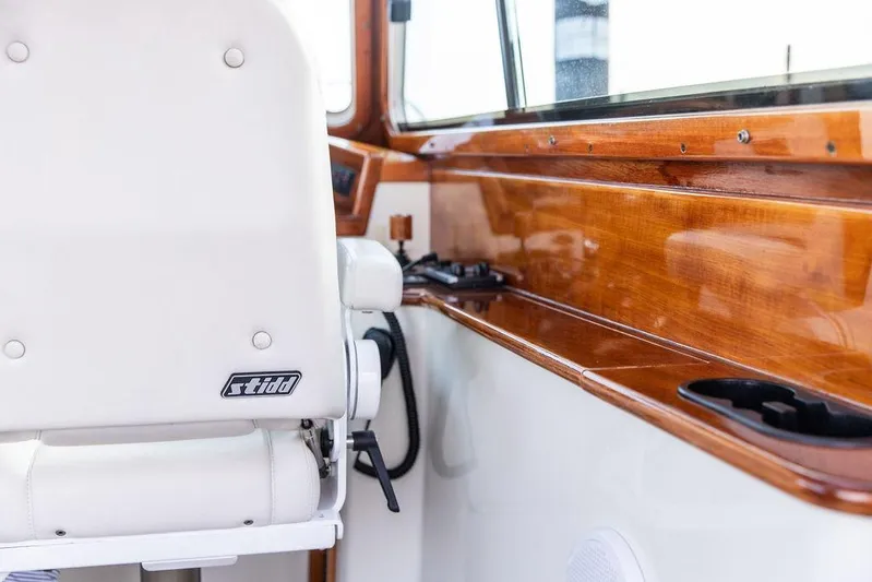 Chaser Yacht Photos Pics Interior of 2004 Hinckley Picnic Boat EP with white Stidd seat and polished wood finish.