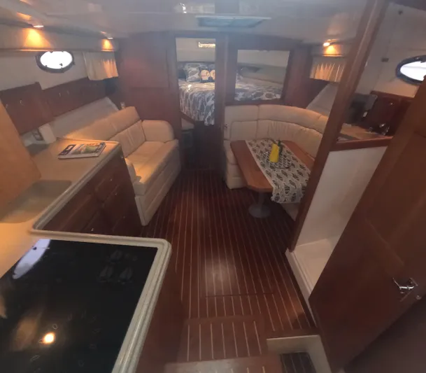  Yacht Photos Pics Interior of a 2005 Stamas 370 Express yacht with wood flooring and cozy seating.