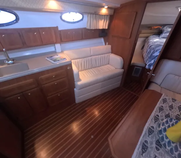  Yacht Photos Pics Interior of 2005 Stamas 370 Express yacht with wood flooring and cozy seating area.