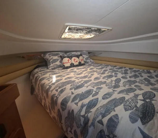  Yacht Photos Pics Cozy cabin interior of 2005 Stamas 370 Express with patterned bedding and decorative pillows.
