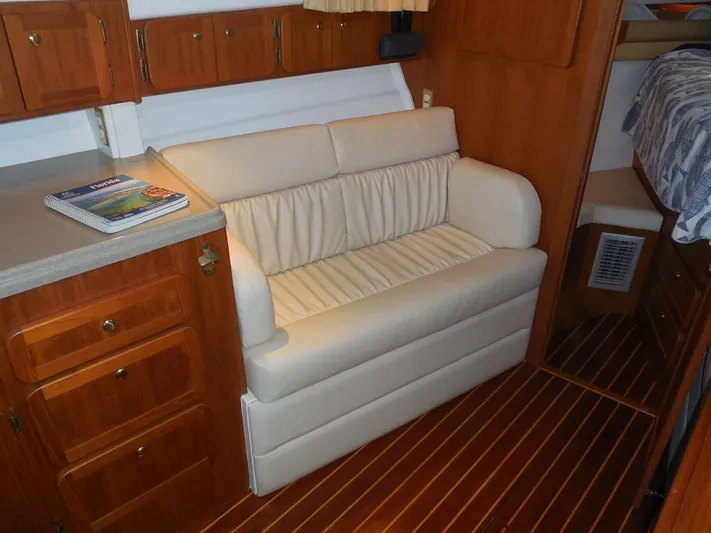  Yacht Photos Pics Interior of 2005 Stamas 370 Express with white sofa and wooden cabinetry.