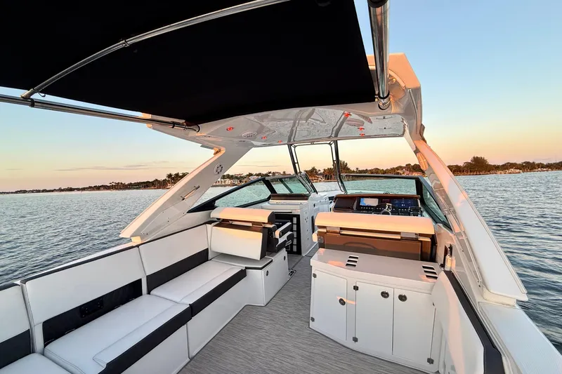  Yacht Photos Pics 2022 Monterey 385SS Super Sport boat interior with sleek seating and modern dashboard on calm water.