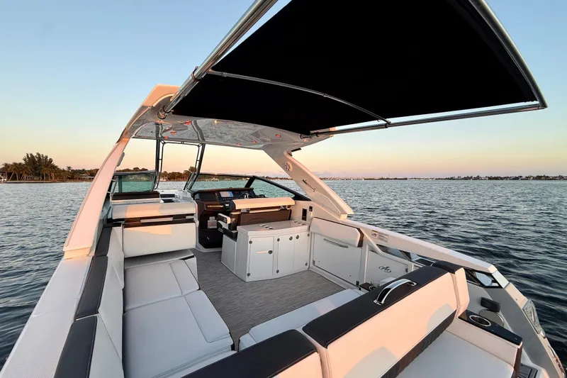  Yacht Photos Pics 2022 Monterey 385SS Super Sport boat interior with seating and canopy on calm water.