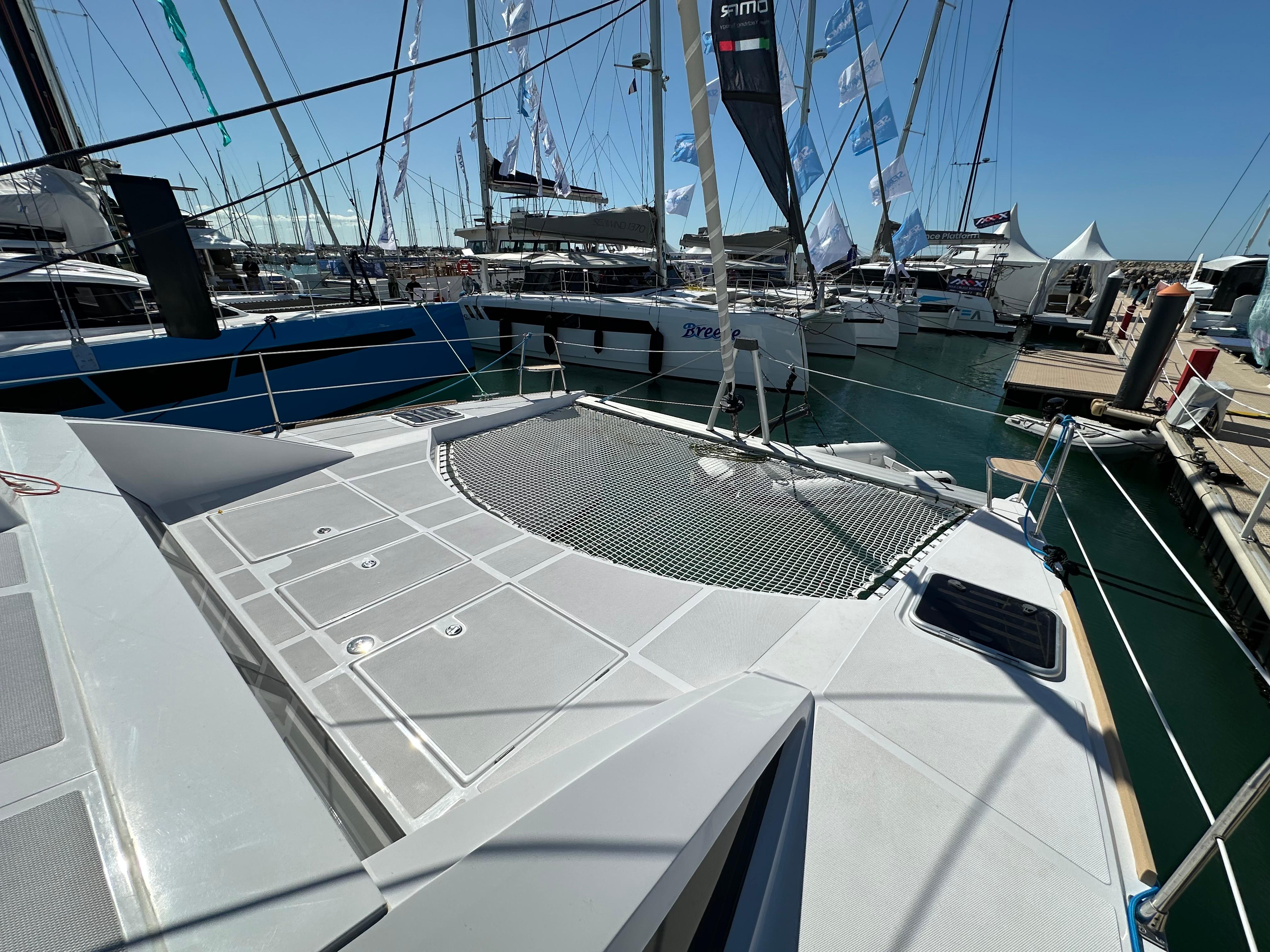 2025 Comar C-Cat 38 Catamaran docked at marina, showcasing deck and netting.