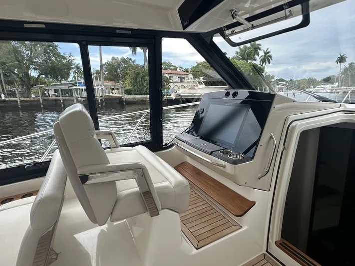 Isle Hope'n Yacht Photos Pics 2022 Boston Whaler 405 Conquest helm with modern controls and waterfront view.