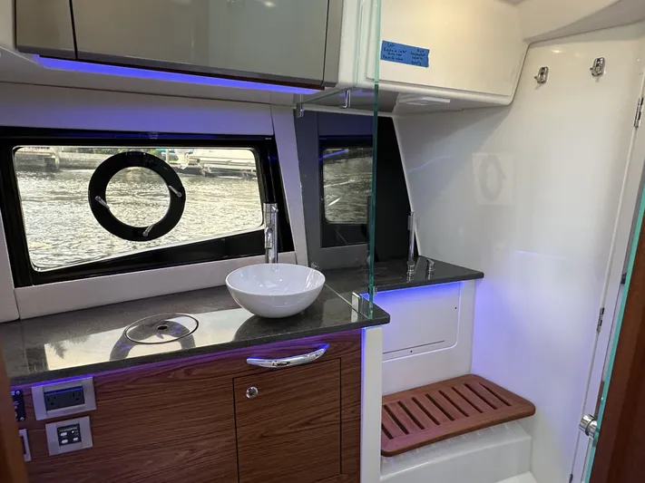 Isle Hope'n Yacht Photos Pics Interior of 2022 Boston Whaler 405 Conquest, featuring modern bathroom with sink and window.
