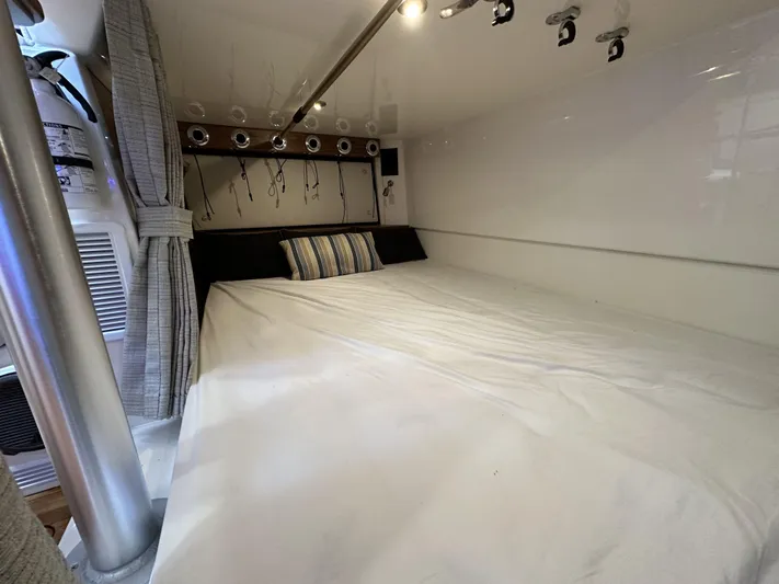 Isle Hope'n Yacht Photos Pics Interior cabin of 2022 Boston Whaler 405 Conquest with cozy bed and striped pillow.