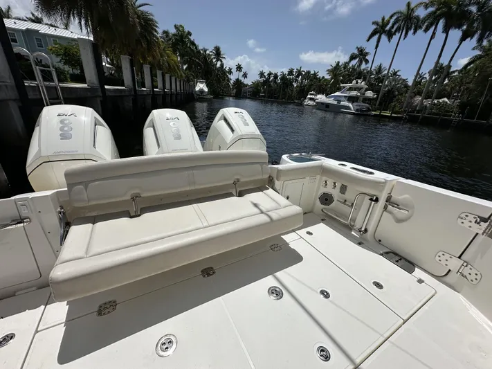 Isle Hope'n Yacht Photos Pics 2022 Boston Whaler 405 Conquest boat with triple engines, docked by a scenic waterfront.