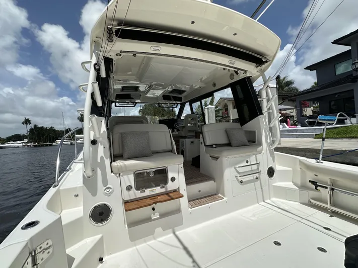 Isle Hope'n Yacht Photos Pics 2022 Boston Whaler 405 Conquest boat interior with seating, docked by waterfront homes.