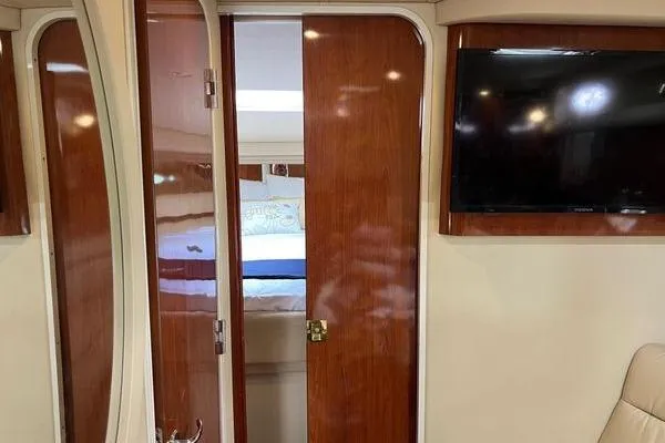  Yacht Photos Pics Interior of 2003 Sea Ray 410 Sundancer with wooden doors and mounted TV.