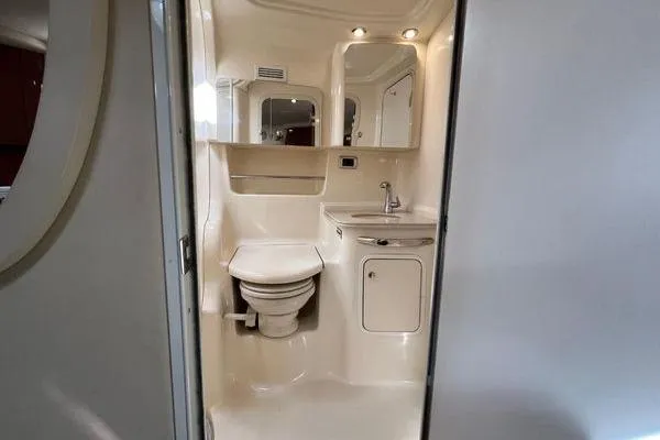  Yacht Photos Pics 2003 Sea Ray 410 Sundancer yacht bathroom with toilet, sink, and mirror.