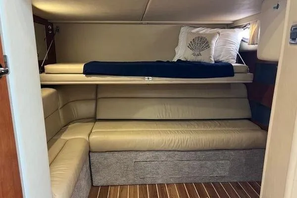  Yacht Photos Pics 2003 Sea Ray 410 Sundancer interior with beige seating and wooden flooring.