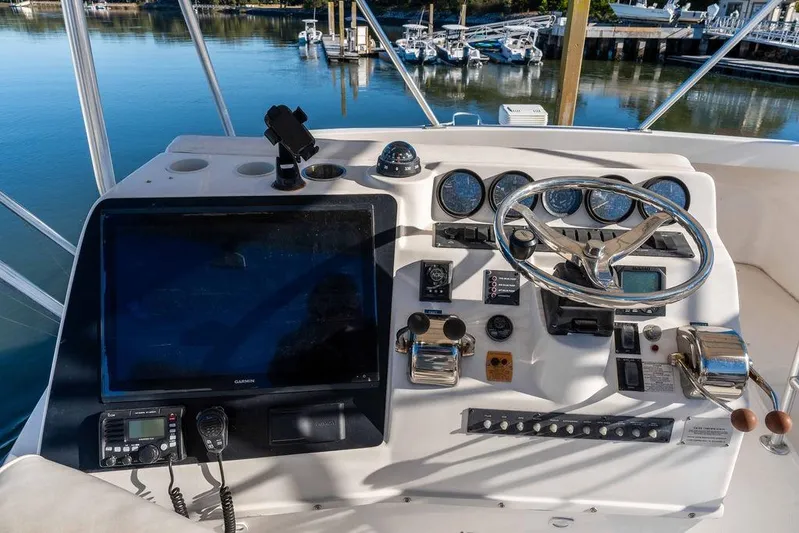  Yacht Photos Pics Helm of 2004 Luhrs 36 Convertible boat with navigation instruments and steering wheel.