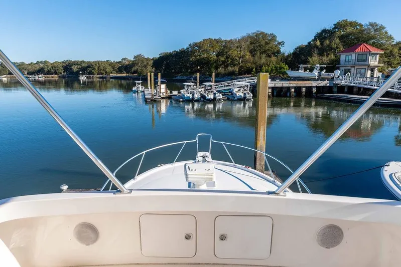  Yacht Photos Pics Bow view of 2004 Luhrs 36 Convertible yacht at a serene marina.
