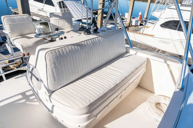  Yacht Photos Pics 2004 Luhrs 36 Convertible boat interior with white seating at marina.