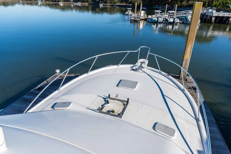  Yacht Photos Pics 2004 Luhrs 36 Convertible yacht docked at a serene marina.