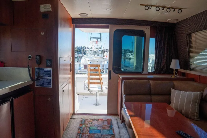  Yacht Photos Pics Interior of 2004 Luhrs 36 Convertible yacht with cozy seating and marina view.