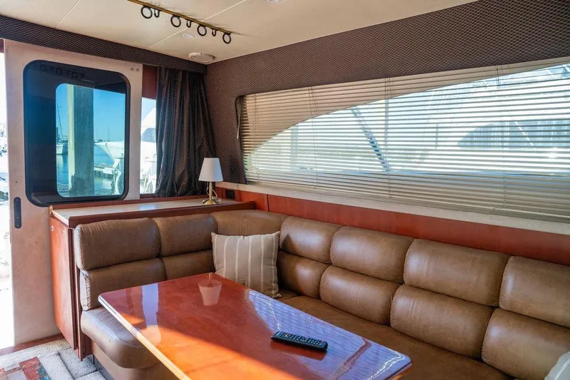  Yacht Photos Pics Interior of 2004 Luhrs 36 Convertible yacht with leather seating and wooden table.
