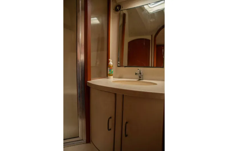  Yacht Photos Pics Bathroom interior of 2004 Luhrs 36 Convertible yacht with sink and mirror.