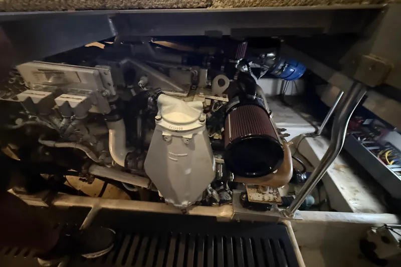  Yacht Photos Pics Engine compartment of a 2005 Luhrs 38 Convertible boat, showcasing mechanical components.