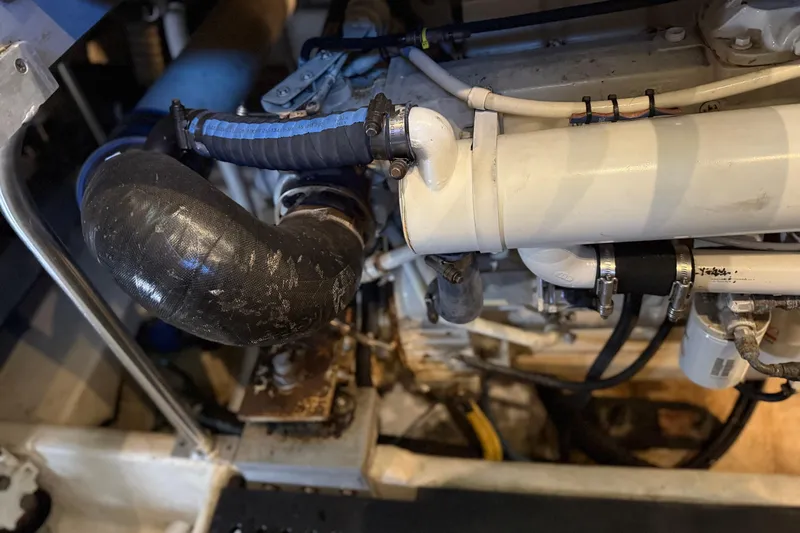  Yacht Photos Pics Engine compartment of a 2005 Luhrs 38 Convertible boat, showing hoses and mechanical components.