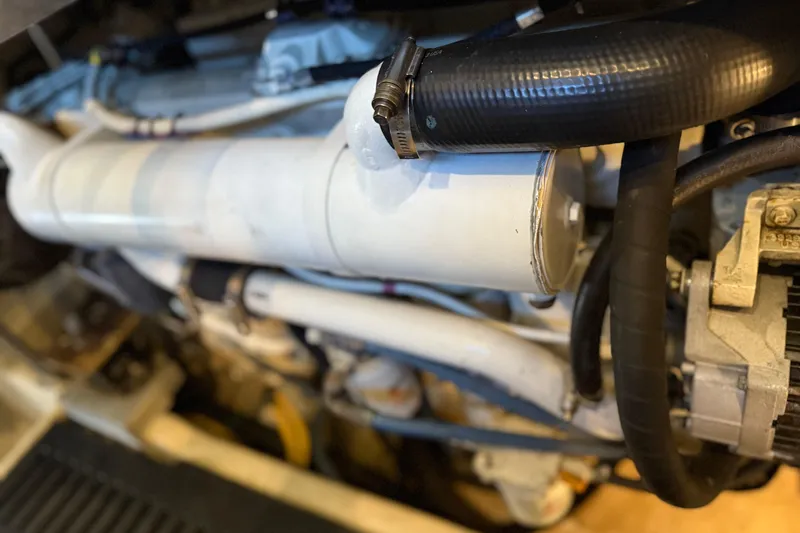  Yacht Photos Pics Engine components of a 2005 Luhrs 38 Convertible boat, featuring hoses and metal parts.