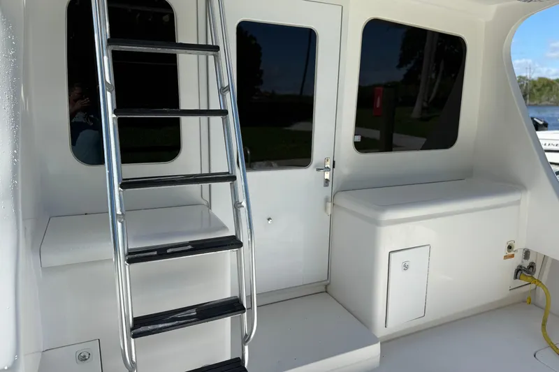  Yacht Photos Pics 2005 Luhrs 38 Convertible yacht with ladder and cabin door.