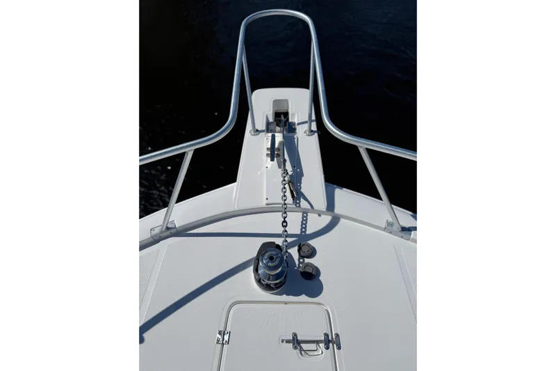  Yacht Photos Pics Bow view of 2005 Luhrs 38 Convertible boat with anchor chain and railing.