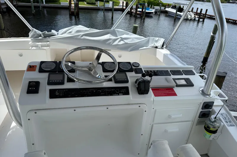  Yacht Photos Pics 2005 Luhrs 38 Convertible boat helm with steering wheel and control panel.