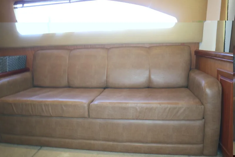  Yacht Photos Pics Brown leather sofa inside 2005 Luhrs 38 Convertible boat cabin.