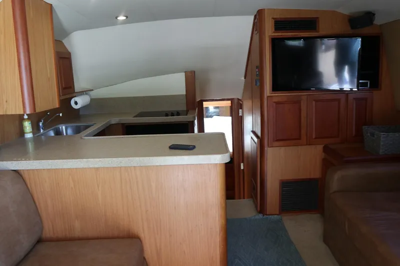  Yacht Photos Pics Interior of 2005 Luhrs 38 Convertible yacht with kitchen and seating area.