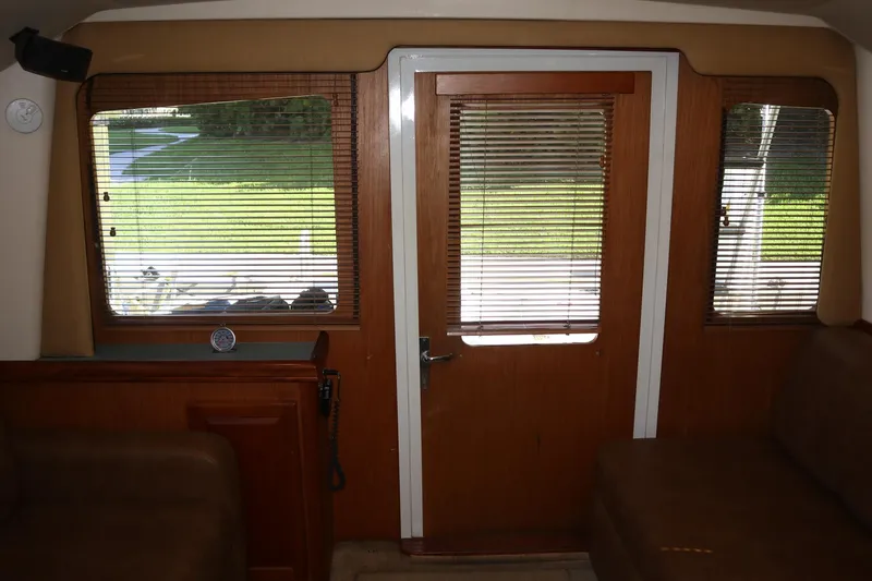  Yacht Photos Pics Interior view of 2005 Luhrs 38 Convertible yacht with wooden door and windows.