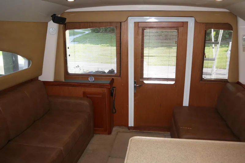 Yacht Photos Pics Interior of 2005 Luhrs 38 Convertible yacht with brown seating and wooden door.