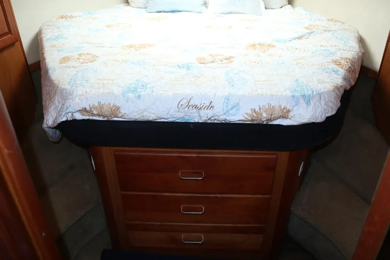  Yacht Photos Pics 2005 Luhrs 38 Convertible cabin with cozy bed and wooden storage drawers.