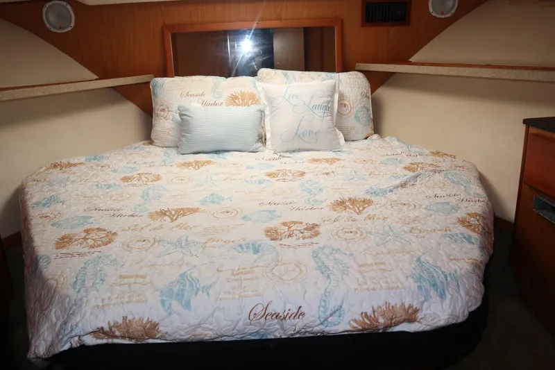  Yacht Photos Pics Cozy bedroom in 2005 Luhrs 38 Convertible yacht with nautical-themed bedding.