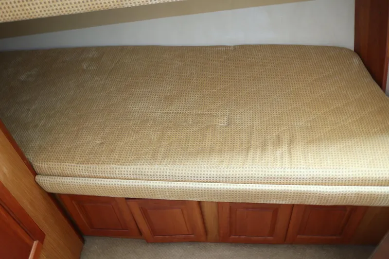  Yacht Photos Pics 2005 Luhrs 38 Convertible cabin bed with wooden storage cabinets.