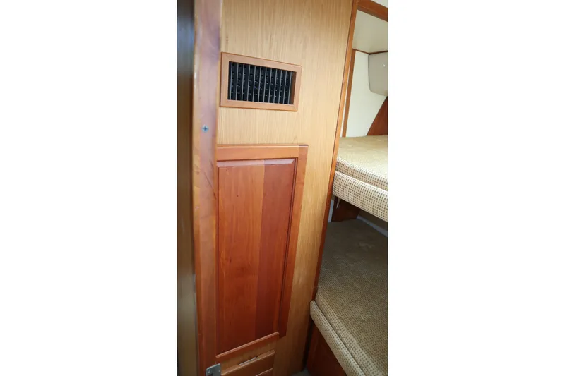  Yacht Photos Pics Interior view of 2005 Luhrs 38 Convertible boat with wooden paneling and bunk beds.