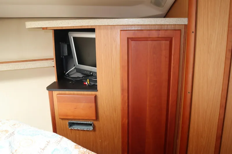  Yacht Photos Pics 2005 Luhrs 38 Convertible interior with built-in TV and wooden cabinetry.