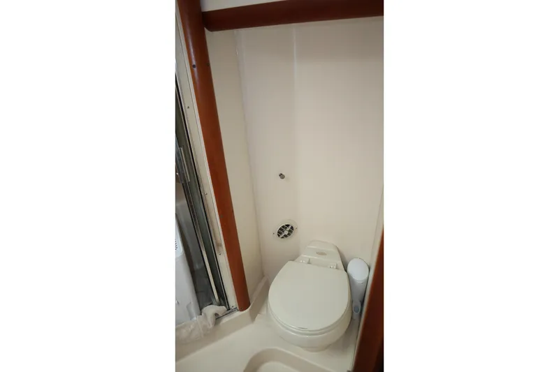  Yacht Photos Pics 2005 Luhrs 38 Convertible boat bathroom with compact toilet and shower area.