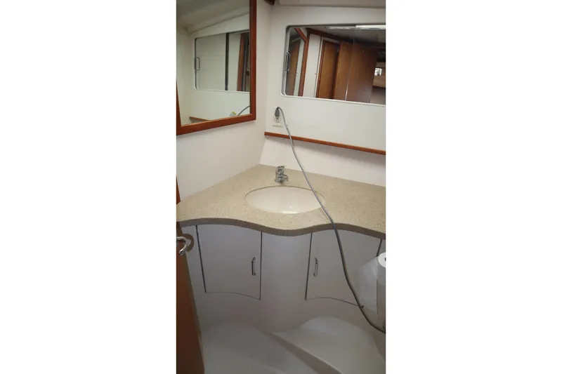  Yacht Photos Pics Bathroom interior of 2005 Luhrs 38 Convertible yacht with sink and mirror.