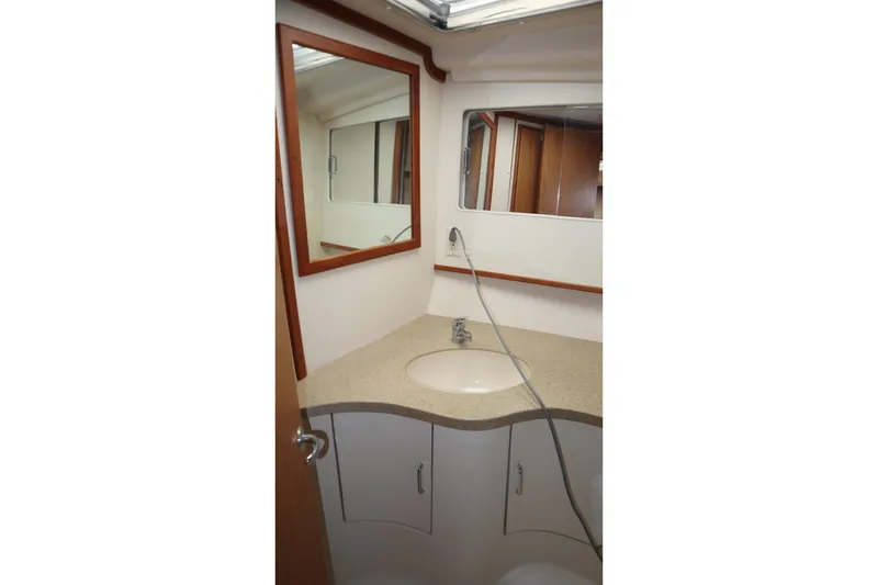  Yacht Photos Pics 2005 Luhrs 38 Convertible yacht bathroom with sink and mirror.