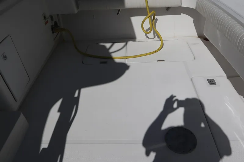  Yacht Photos Pics 2005 Luhrs 38 Convertible boat deck with shadow and yellow cable.