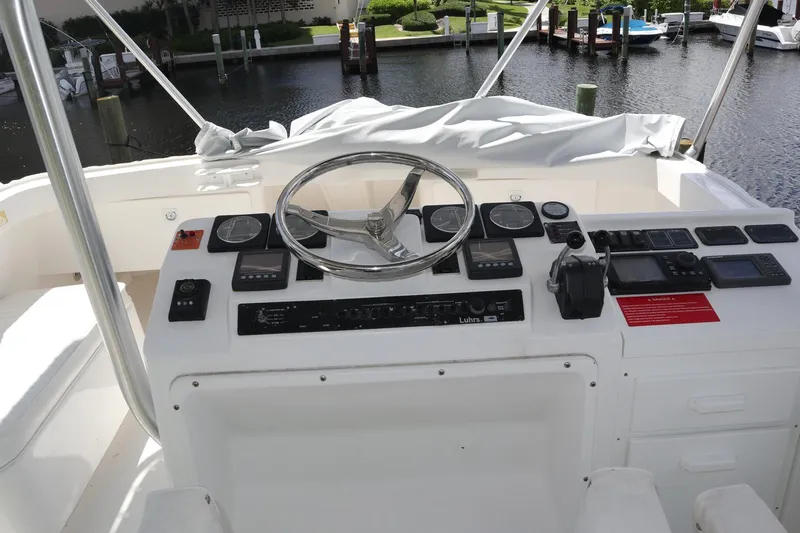  Yacht Photos Pics 2005 Luhrs 38 Convertible boat helm with steering wheel and control panel.