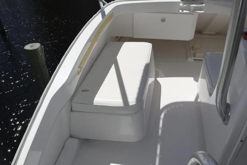  Yacht Photos Pics 2005 Luhrs 38 Convertible boat deck with white seating and storage compartment.