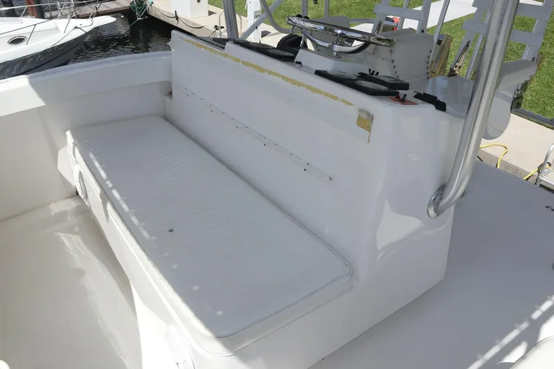  Yacht Photos Pics 2005 Luhrs 38 Convertible boat seating area with white cushioned bench.