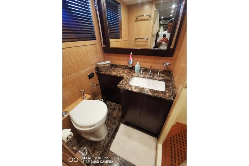 Yacht Photos Pics Luxurious bathroom in 2008 Mangusta 80 yacht with marble countertop and modern fixtures.