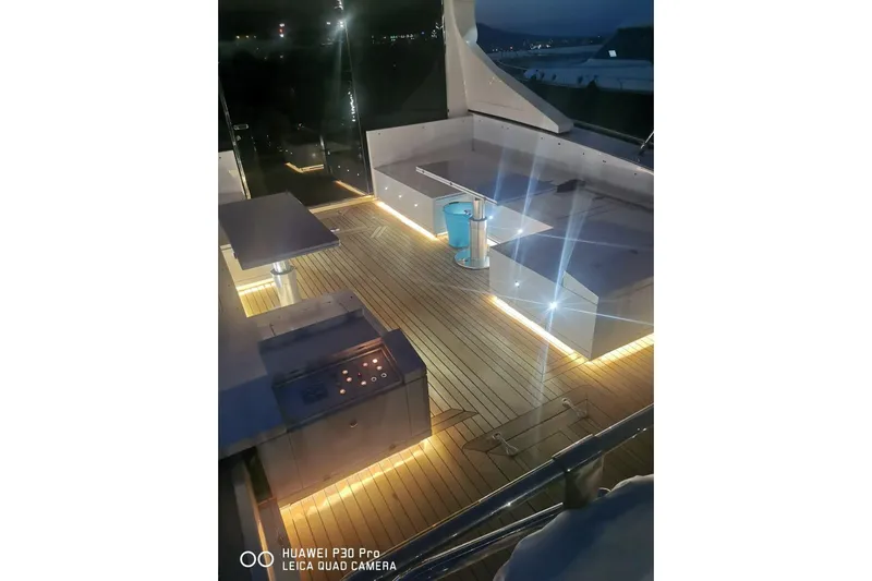  Yacht Photos Pics Luxurious 2008 Mangusta 80 yacht deck with ambient lighting at night.