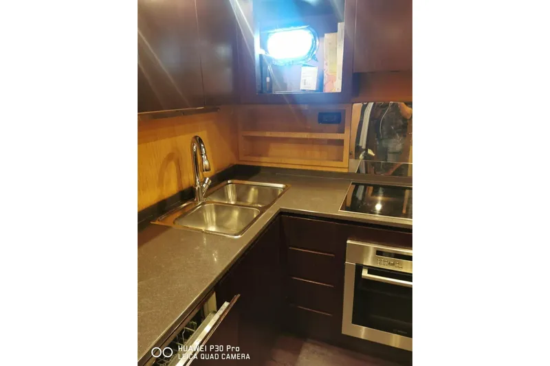  Yacht Photos Pics Luxurious kitchen interior of 2008 Mangusta 80 yacht with modern appliances and sleek design.