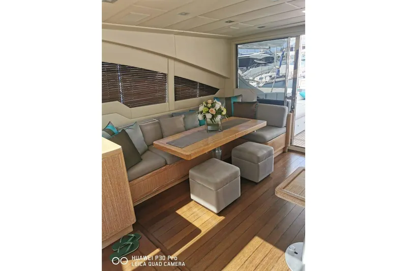  Yacht Photos Pics Luxurious interior of 2008 Mangusta 80 yacht with elegant seating and wooden table.