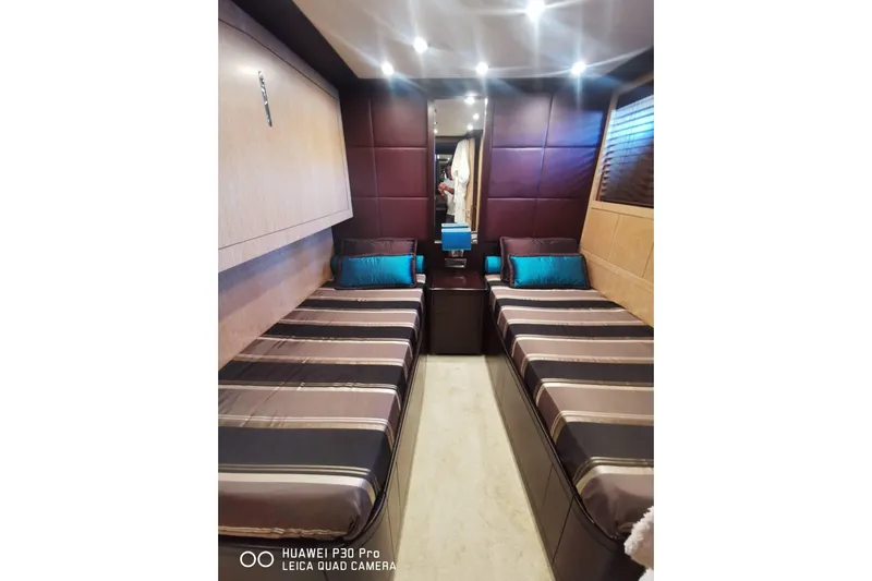  Yacht Photos Pics Luxurious twin cabin interior of 2008 Mangusta 80 yacht with modern decor.